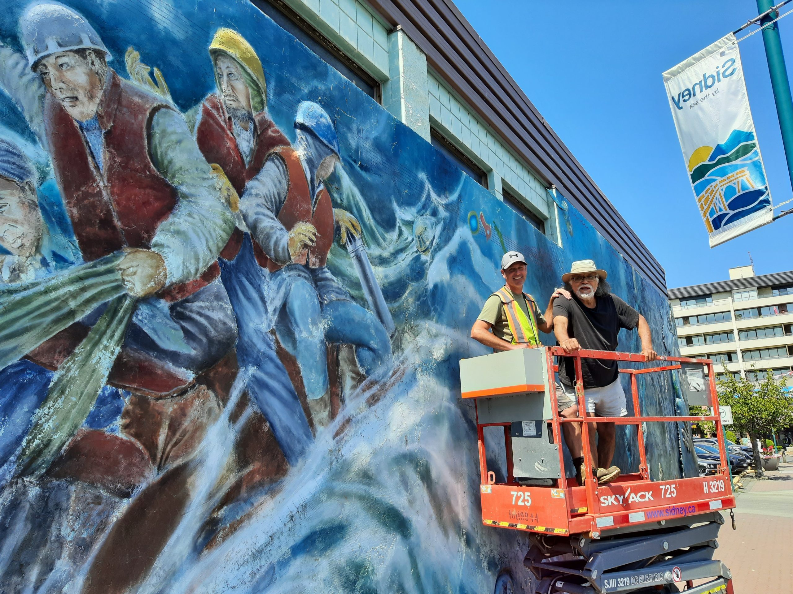 Mural includes IceBear and town staff member on lift