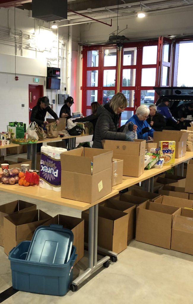 Opening boxes at firehall during Food Drive