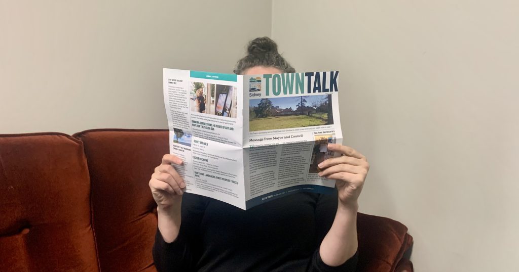 Town Talk Winter 2024 being enjoyed by person on couch