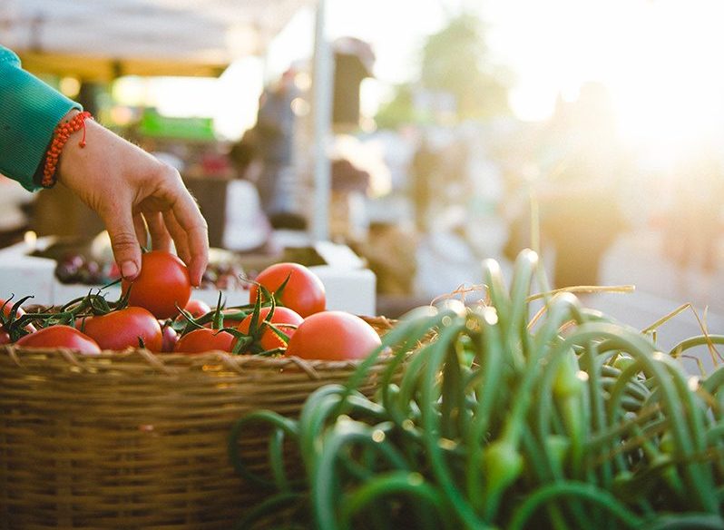 Sidney Market. Hand reaching for tomatoes